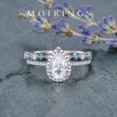 a diamond ring with blue stones on top and the words mohriings above it