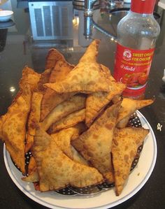 some food is sitting on a plate next to a bottle