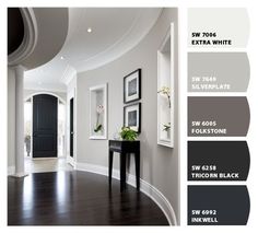 an image of a room with white walls and wood flooring in shades of gray