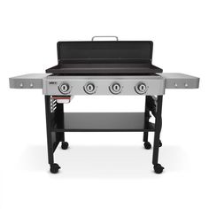 an outdoor grill with four burners and two shelves on the side, in front of a white background