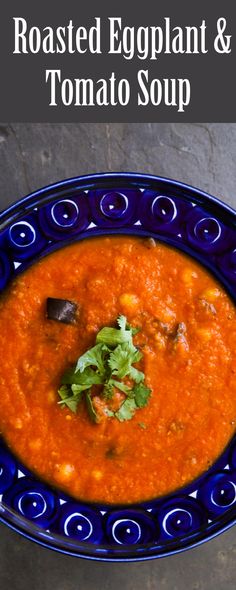 roasted eggplant and tomato soup in a blue bowl with cilantro garnish