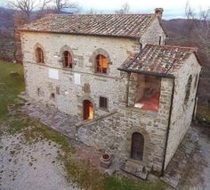 an old stone building with two windows