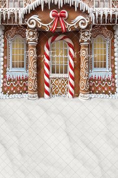 a gingerbread house with candy canes and icing on the front door window