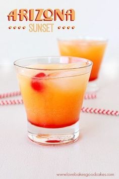 two glasses filled with drinks sitting on top of a table