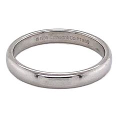 a silver wedding ring with the word,'love is in the air'written on it