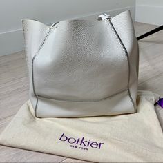 Nwot. Botkier Soho Bite Size Leather Tote Bag Un Off White. 100% Leather Chunky Decorative Zips Bring An Industrial Edge To This Botkier Tote. Raw Top. Metallic Interior With 2 Pockets. Double Handles. Dust Bag Included. Leather: Cowhide. Weight: 38oz / 1.08kg. Imported, Us Measurements Height: 12.5in / 32cm Length: 18in / 46cm Depth: 5.5in / 14cm Handle Drop: 9in / 23cm White Shoulder Bag With Palladium Hardware For Office, White Shoulder Bag With Palladium Hardware For Daily Use, Daily Use White Shoulder Bag With Palladium Hardware, White Calf Leather Shoulder Bag For Daily Use, White Soft Leather Bags, White Calf Leather Shoulder Bag With Removable Pouch, White Calf Leather Shoulder Bag With Soft Leather, White Calf Leather Bag With Silver-tone Hardware, White Rectangular Calf Leather Shoulder Bag