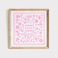 a pink and white framed print with flowers on it that says home, sweet home