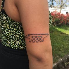 a woman with a tattoo on her arm that has three stars in the shape of an arrow