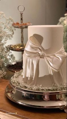 a white wedding cake with a bow on top