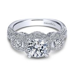 an 18k white gold engagement ring with three round diamonds on the side and sides