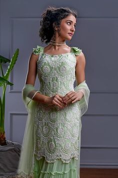 Mint green short frilly sleeves kurta with all over ambrosia embroidery using dori, bugle bead, sequin, pearls highlights. Paired with a gathered frilly tiered sharara and a pearl tasseled tulle dupatta. - Aza Fashions Green Ruffled Sets For Diwali, Green Dress For Diwali Reception, Fitted Green Dress With Dori Work, Green Fitted Dress With Dori Work, Green Diwali Reception Dress, Green Ruffled Sharara For Diwali, Green Dori Work Dresses, Designer Green Dress With Ruffles, Green Dresses With Dori Work