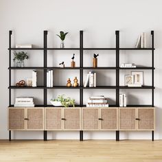 a book shelf with books and vases on it