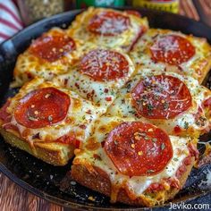 pepperoni and cheese pizza in a pan on a table