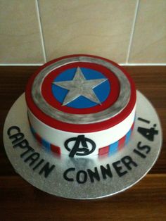 a captain america themed birthday cake on a table