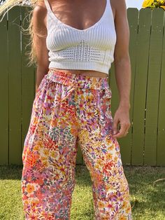 Ditch those boring trousers and upgrade to our Tulip Gardens beach pants! Featuring a flared leg and unique split tulip hem, these printed pants will have you turning heads. Made with 100% rayon for a comfortable and stylish fit. Get ready to stand out in these fun and playful pants! Casual Boho Print Pants For Vacation, Summer Vacation Boho Print Bottoms, Multicolor Beach Pants For Spring, Hippie Boho Print Vacation Bottoms, Spring Multicolor Beach Pants, Multicolor Spring Beach Pants, Multicolor Pants For Beach And Spring Season, Bohemian Floral Print Beach Bottoms, Summer Beach Boho Print Bottoms