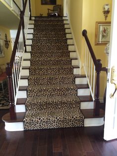 a leopard print carpeted staircase leading up to the second floor