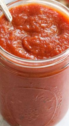 a jar filled with sauce sitting on top of a table