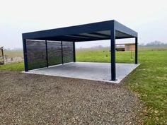 a large metal structure in the middle of a field