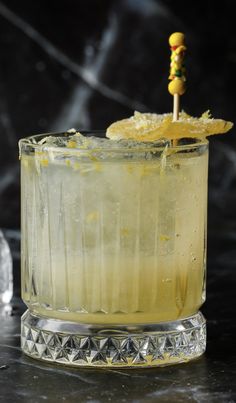 a close up of a drink with a toothpick sticking out of the top