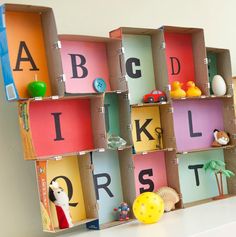 a book shelf with letters and toys in it