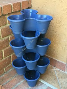 a stack of blue plastic buckets sitting on the ground