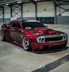 a red and black car parked in a garage