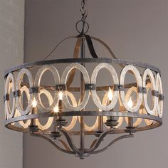 a chandelier hanging from the ceiling with circles and rings on it's sides