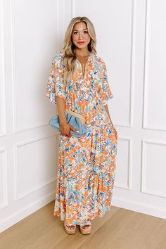 - Your style will blossom like a wildflower with this breezy dress! - Lightweight material with floral print - A built-in partial skirt lining ending thigh length - A v-cut neckline with two hidden hook and eyes for additional coverage - Loose short sleeves - A cinched waistline with an elastic back - A flowy yet flattering silhouette that ends in a straight maxi length hemline Orange Floral Print Maxi Dress For Summer, Bohemian Orange Maxi Dress For Spring, Spring Orange Boho Print Maxi Dress, Orange Bohemian Dress For Spring, Spring Orange Printed Maxi Dress, Orange Spring Vacation Dress, Spring Floral Dress With Boho Print For Garden Party, Bohemian Orange Maxi Dress For Garden Party, Bohemian Orange Midi Dress For Garden Party