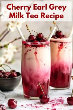 two glasses filled with cherries on top of a table