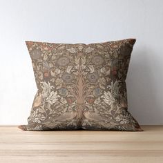 a decorative pillow sitting on top of a wooden table