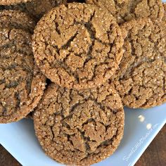 a white plate topped with cookies on top of a wooden table