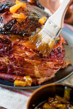 a large piece of meat is being brushed with a brush