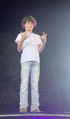 a young man standing on top of a stage