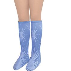 the legs and ankles of a woman wearing blue socks with stars on them, while standing in front of a white background