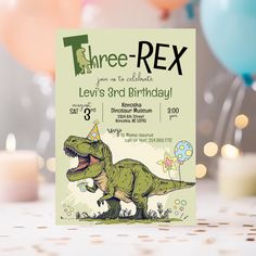 a dinosaur birthday party with balloons and confetti on the table, including candles