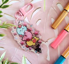 two pens, one with an ice cream and the other with cartoon characters on it