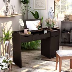 a desk with a mirror and some plants