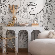 a living room with black and white wallpaper on the walls, a chair and table