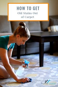 a woman is cleaning the carpet with a spray bottle