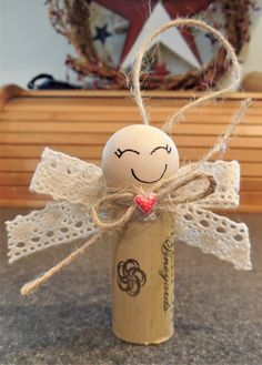 an angel made out of wine corks sitting on top of a table