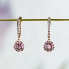 Whimsical yet elegant, Hanaka features a pair of blush-pink Rosé sapphires cut in the shape of an open blossom and framed by petals of glistening moissanites. In the drop style, the blooms dangle delicately from studded huggie hoops, adding a touch of elegance to the delightful spirit of spring. Made to order. Please allow 6-8 weeks for delivery. DETAILS: Gemstone: Type: Sapphire (cultured) Size: 6 mm (each) Color: Rosé Pink Cut: Blossom Design: Style: Drop Accents: Round Brilliant Moissanites B Elegant Pink Sapphire Jewelry With Halo Design, Elegant Pink Sapphire Halo Jewelry, Pink Sapphire Earrings For Wedding, Pink Brilliant Cut Earrings In Fine Jewelry Style, Pink Diamond Earrings With Accents For Wedding, Pink Diamond Earrings With Diamond Accents For Wedding, Elegant Pink Sapphire Earrings For Wedding, Elegant Pink Sapphire Earrings For Formal Events, Elegant Pink Sapphire Earrings For Formal Occasions