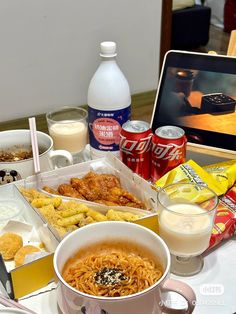 a table topped with lots of food and drinks