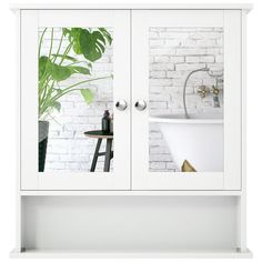 a white bathroom cabinet with two mirrors on the front and one door open to reveal a bathtub