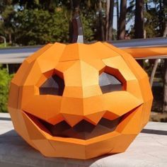 an orange paper pumpkin sitting on top of a table