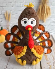 a crocheted turkey sitting on top of a wooden table