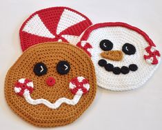 two crocheted coasters with faces on them, one in red and the other in white