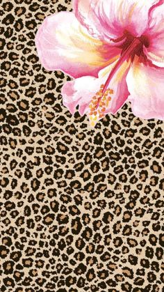 a pink flower sitting on top of a leopard print background