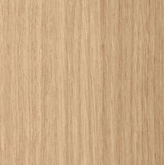 a close up view of the grained surface of a wood paneling material that is light brown