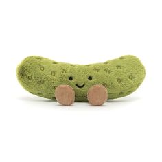 a green stuffed animal with two pink legs