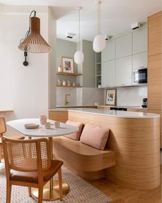 a kitchen and dining area with wooden furniture